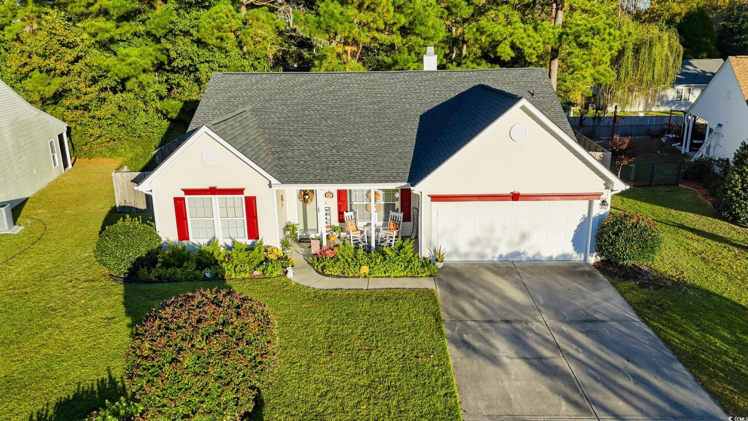 236 Devonbrook Place Longs, SC 29568 - Photo 2 of 40 View of front of home with a shingled roof, a garage, driveway, and a chimney