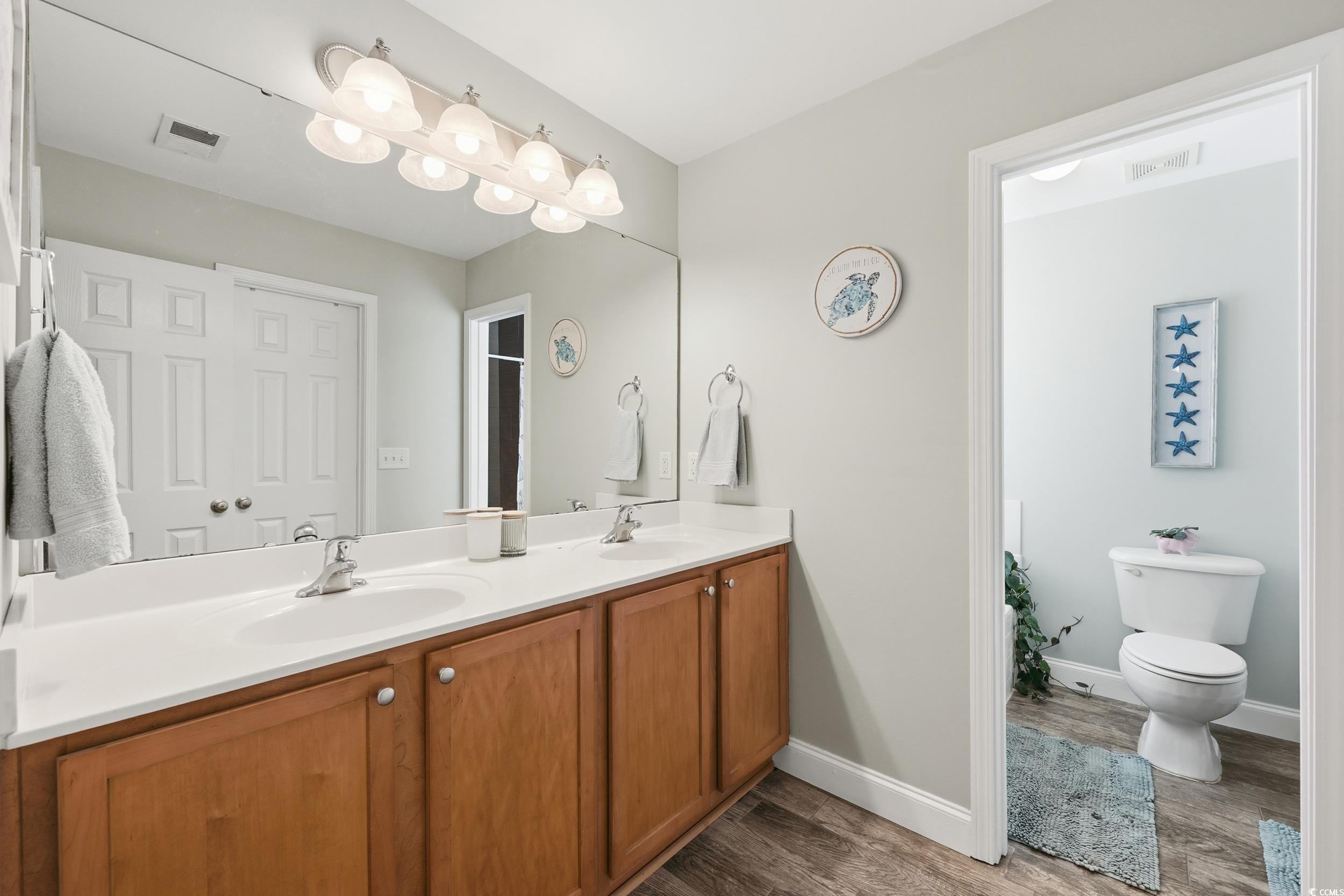 236 Devonbrook Place Longs, SC 29568 - Photo 26 of 40 Bathroom featuring double vanity and dark wood-type flooring