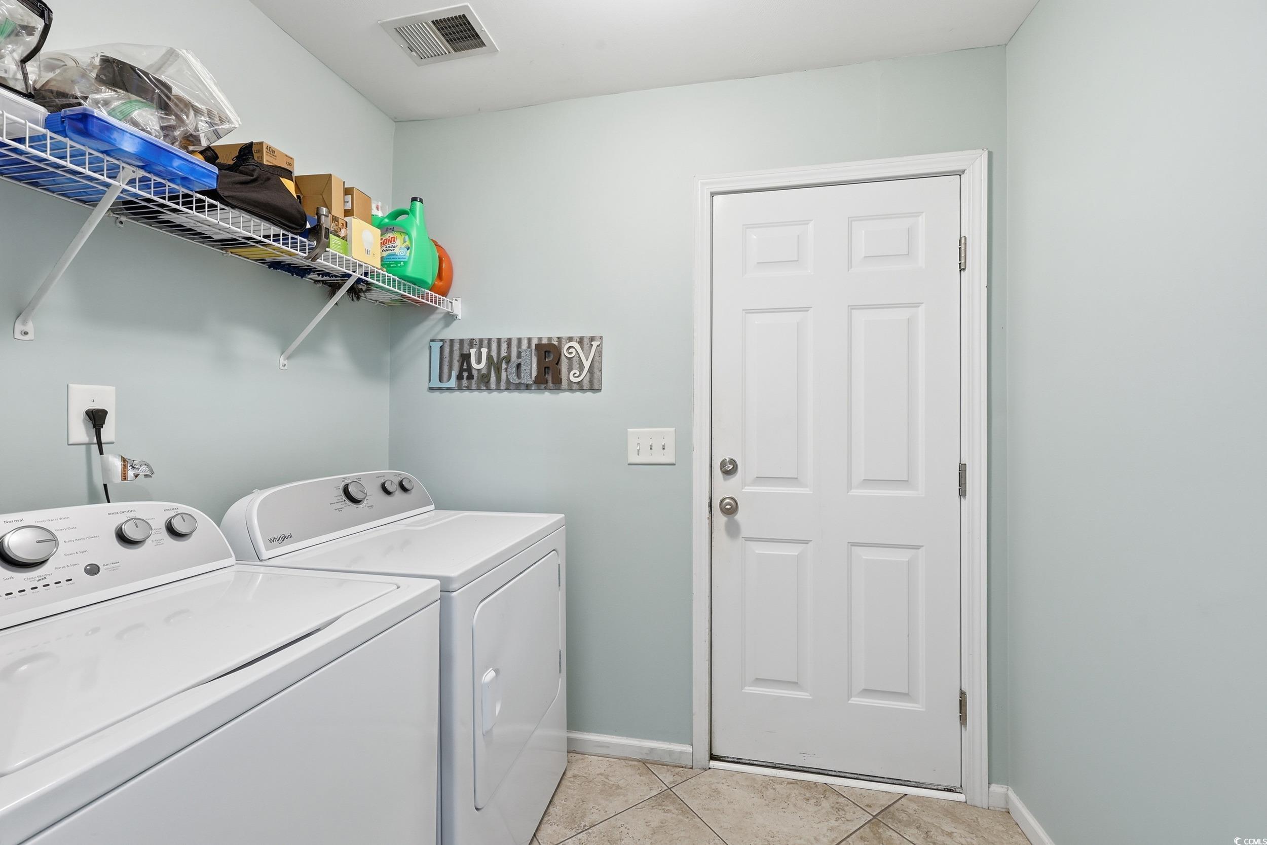 236 Devonbrook Place Longs, SC 29568 - Photo 30 of 40 Laundry room with light tile patterned floors and washing machine and clothes dryer