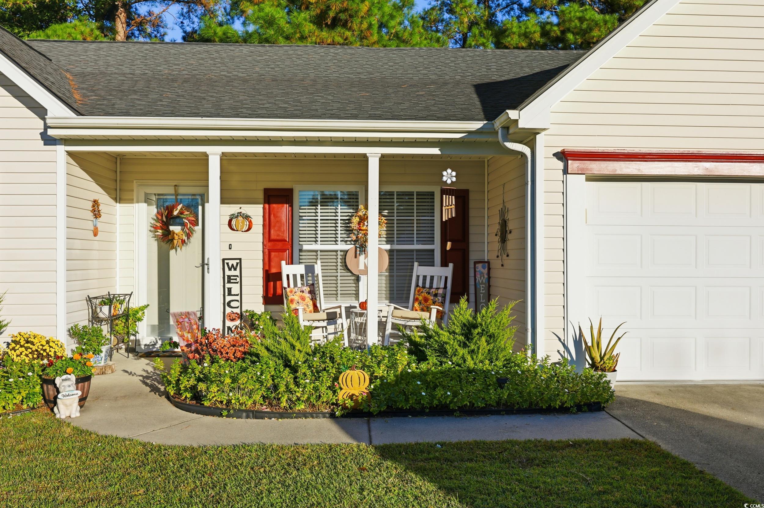 236 Devonbrook Place Longs, SC 29568 - Photo 3 of 40 Property entrance with a porch, a shingled roof, and a garage