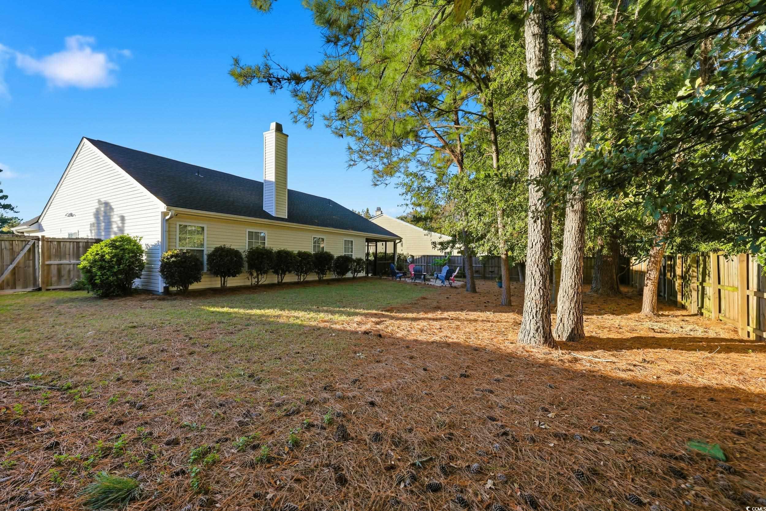 236 Devonbrook Place Longs, SC 29568 - Photo 36 of 40 Rear view of house featuring a fenced backyard and a chimney