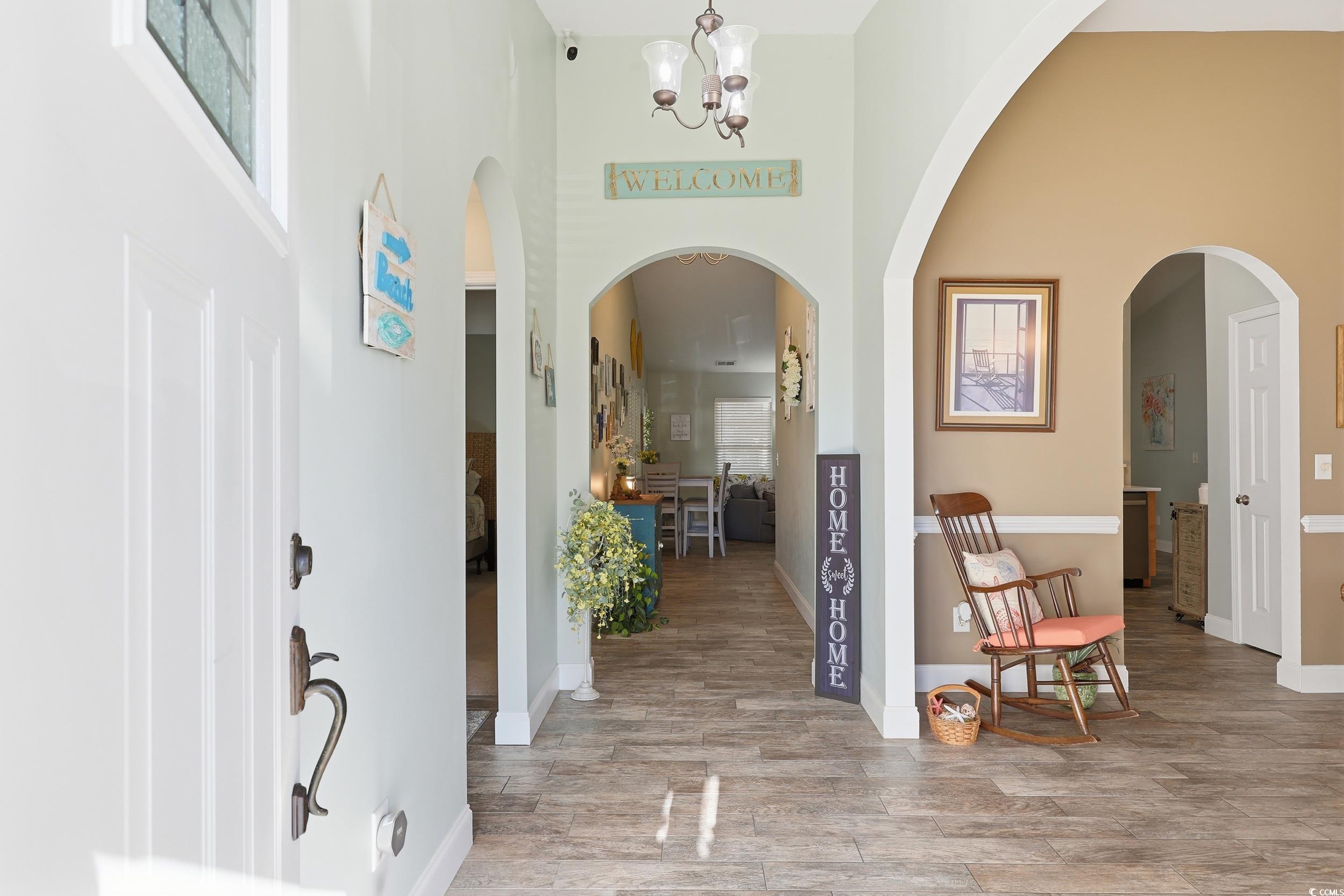 236 Devonbrook Place Longs, SC 29568 - Photo 4 of 40 Hall featuring a high ceiling, a chandelier, and light wood-type flooring