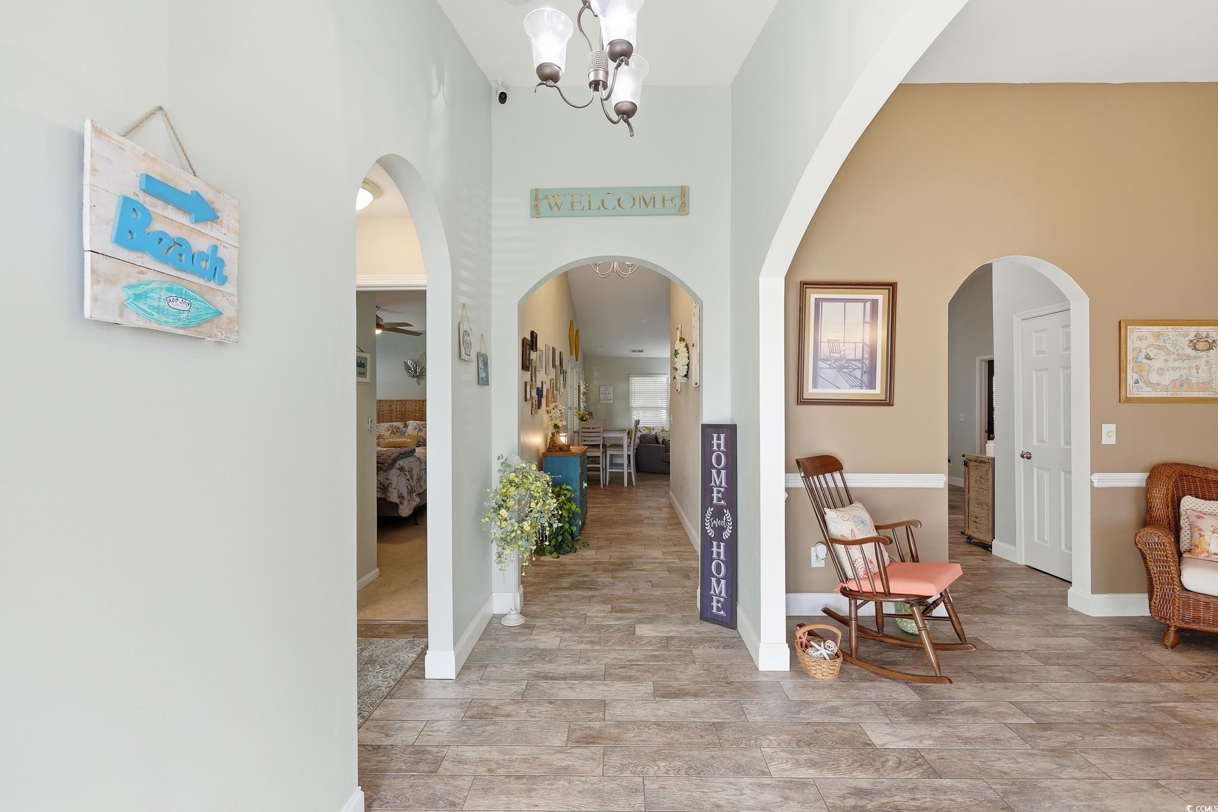 236 Devonbrook Place Longs, SC 29568 - Photo 5 of 40 Entryway featuring a chandelier, arched walkways, and a high ceiling