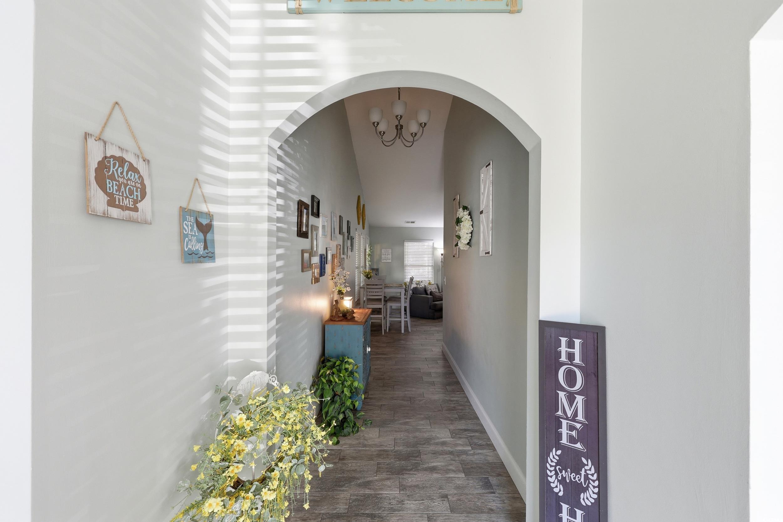 236 Devonbrook Place Longs, SC 29568 - Photo 6 of 40 Corridor with a chandelier, a high ceiling, and arched walkways