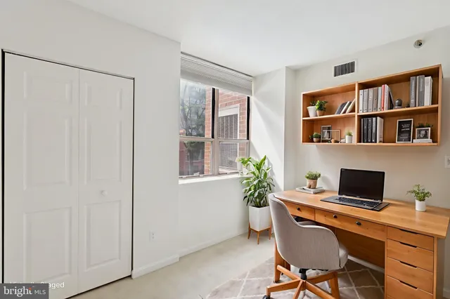 a workspace with furniture and a bookshelf