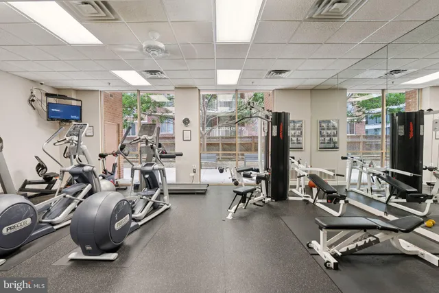a room with gym equipment and a large window