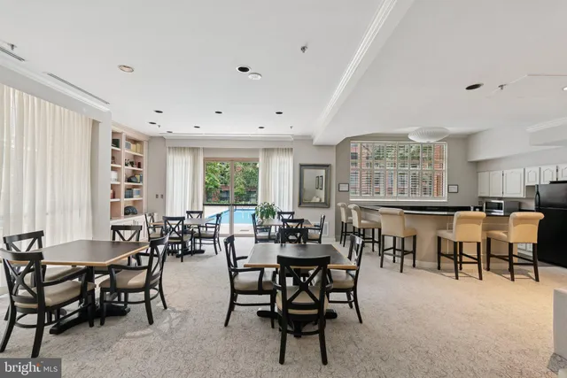 a view of a dining room with furniture and a large window