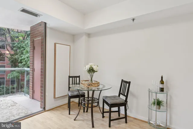 a dining room with furniture and window
