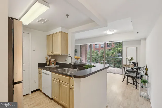 a kitchen with a sink and chairs