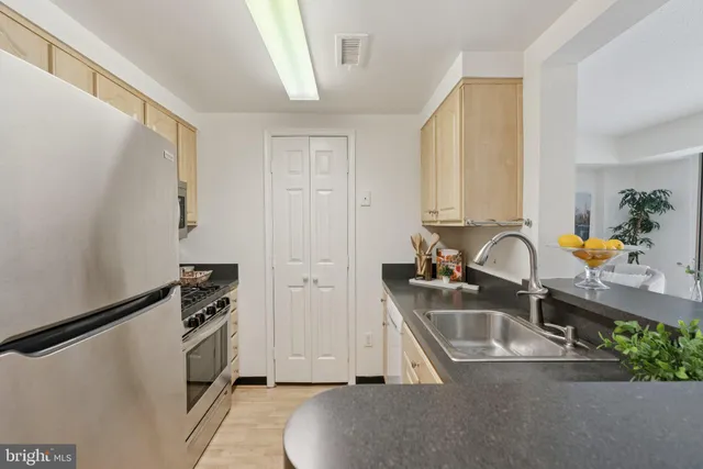 a kitchen with stainless steel appliances a sink a stove and a refrigerator