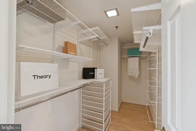 a kitchen with a refrigerator and white cabinets