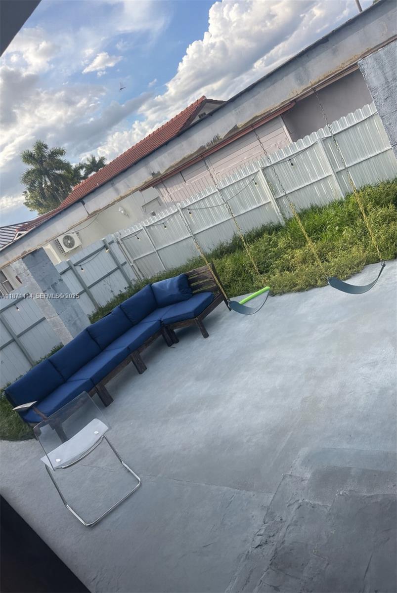 375 East Okeechobee Road Hialeah, FL 33010 - Photo 11 of 13 a backyard of a house with a yard and outdoor seating