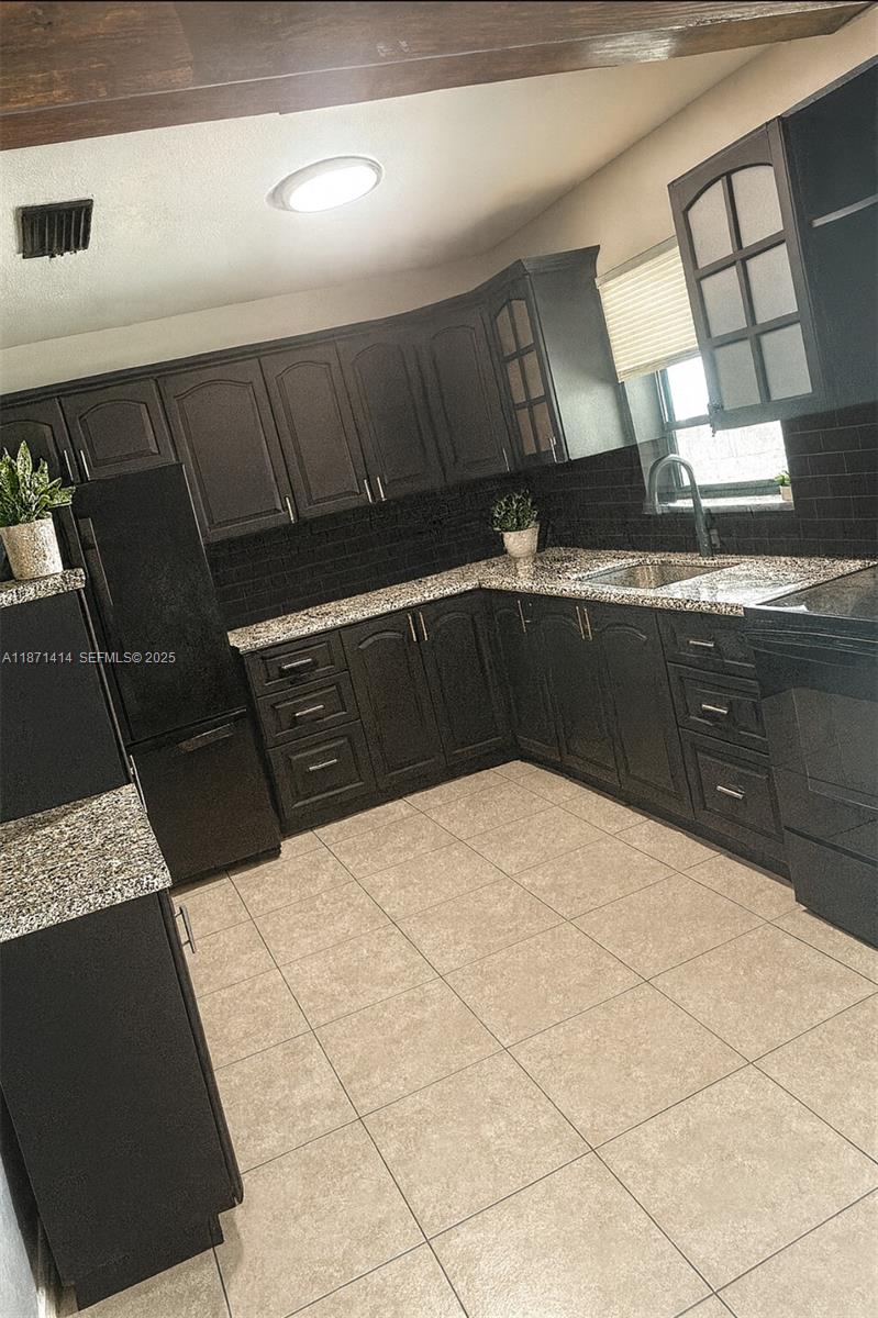 375 East Okeechobee Road Hialeah, FL 33010 - Photo 4 of 13 a kitchen with a sink and cabinets