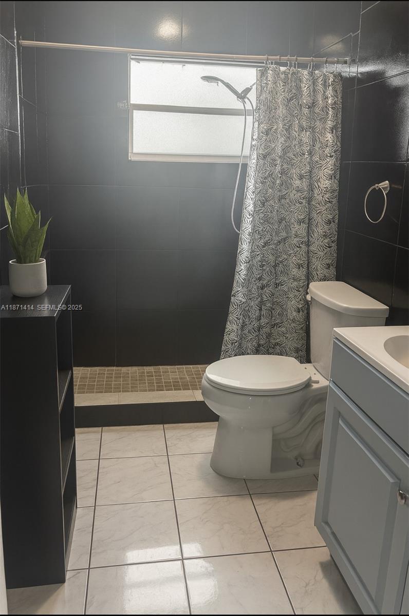 375 East Okeechobee Road Hialeah, FL 33010 - Photo 6 of 13 a bathroom with a toilet a sink and a shower