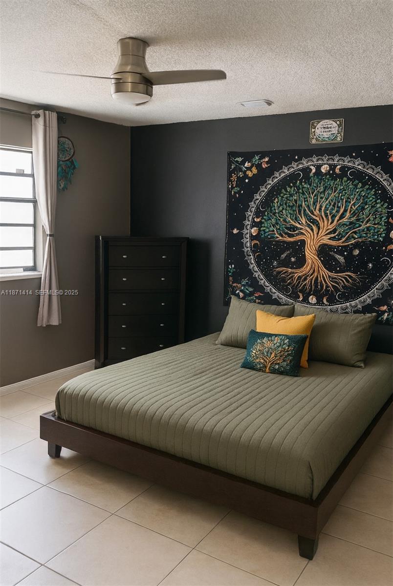 375 East Okeechobee Road Hialeah, FL 33010 - Photo 10 of 13 a bedroom with a bed and wooden floor