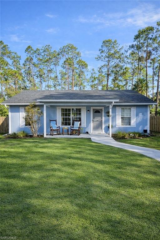 4121 8th Avenue Southeast Naples, FL 34117 - Photo 1 of 10 a front view of a house with a garden