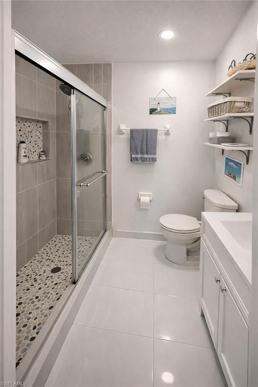 4121 8th Avenue Southeast Naples, FL 34117 - Photo 5 of 10 a bathroom with a sink a toilet and shower