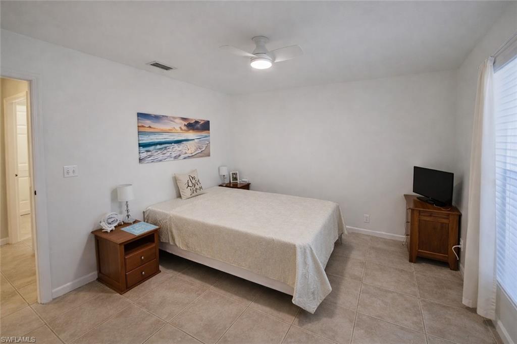 4121 8th Avenue Southeast Naples, FL 34117 - Photo 7 of 10 a bedroom with a bed and a tv