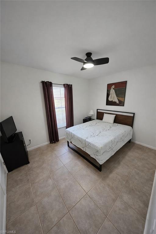 4121 8th Avenue Southeast Naples, FL 34117 - Photo 8 of 10 a bedroom with a bed and dresser