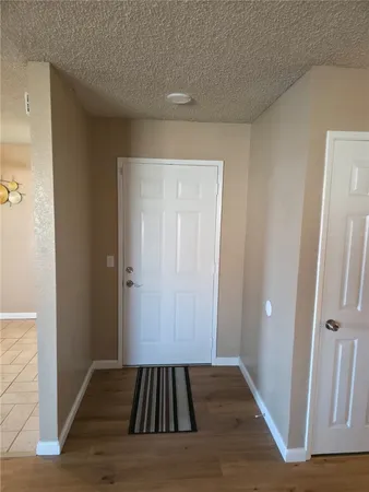 a view of a livingroom with wooden floor and staircase