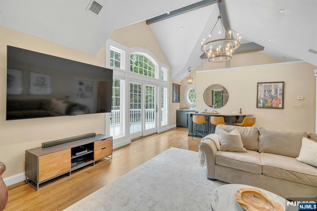 48 Hopper Farm Road Upper Saddle River, NJ 07458 - Photo 31 of 43 a living room with furniture and a flat screen tv