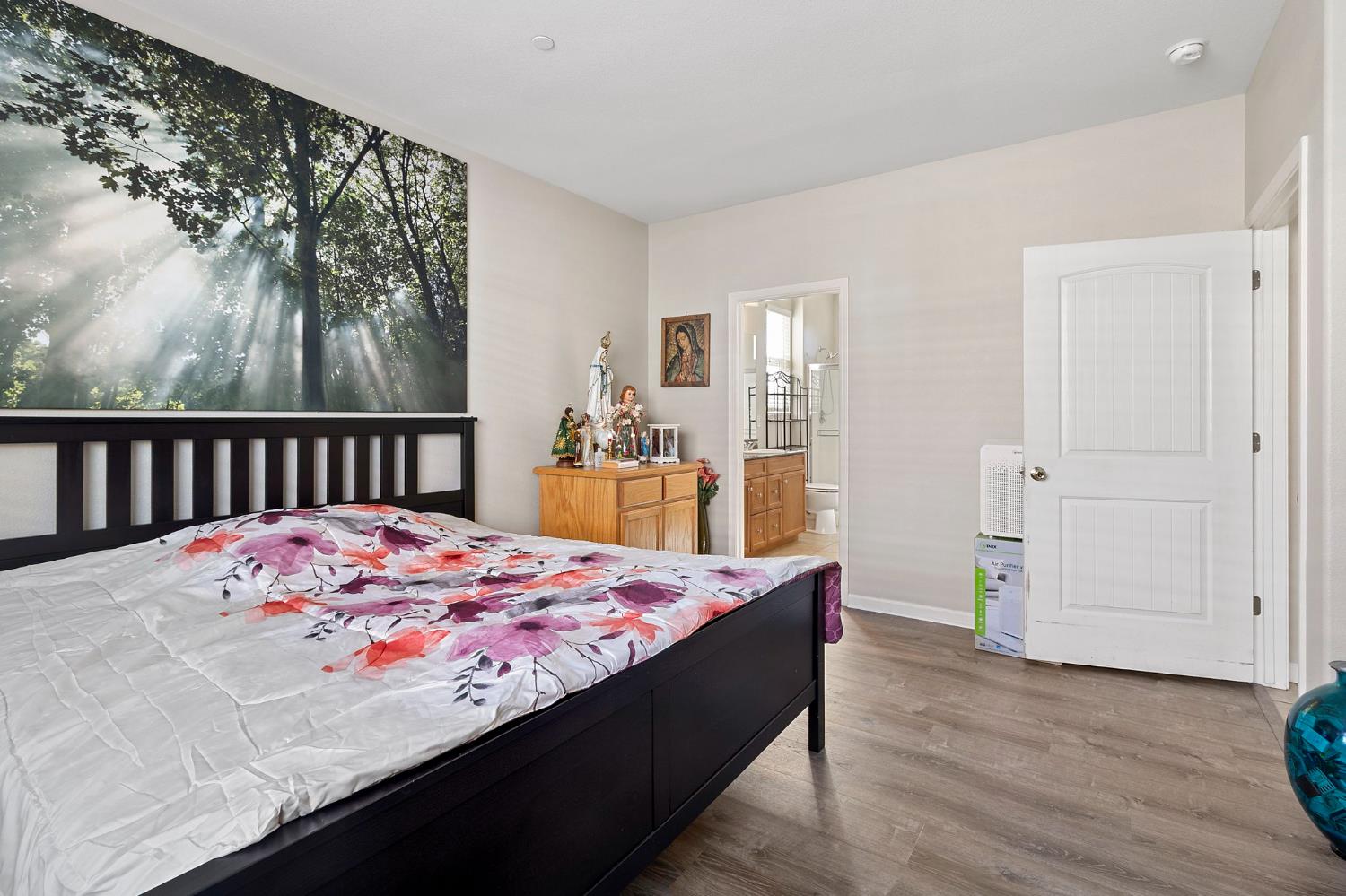 7525 Eldred Way Sacramento, CA 95829 - Photo 11 of 32 a bedroom with a bed and wooden floor