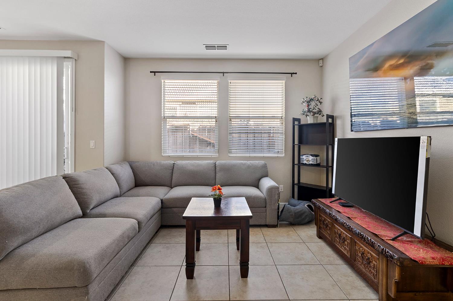 7525 Eldred Way Sacramento, CA 95829 - Photo 13 of 32 a living room with furniture a flat screen tv and a window