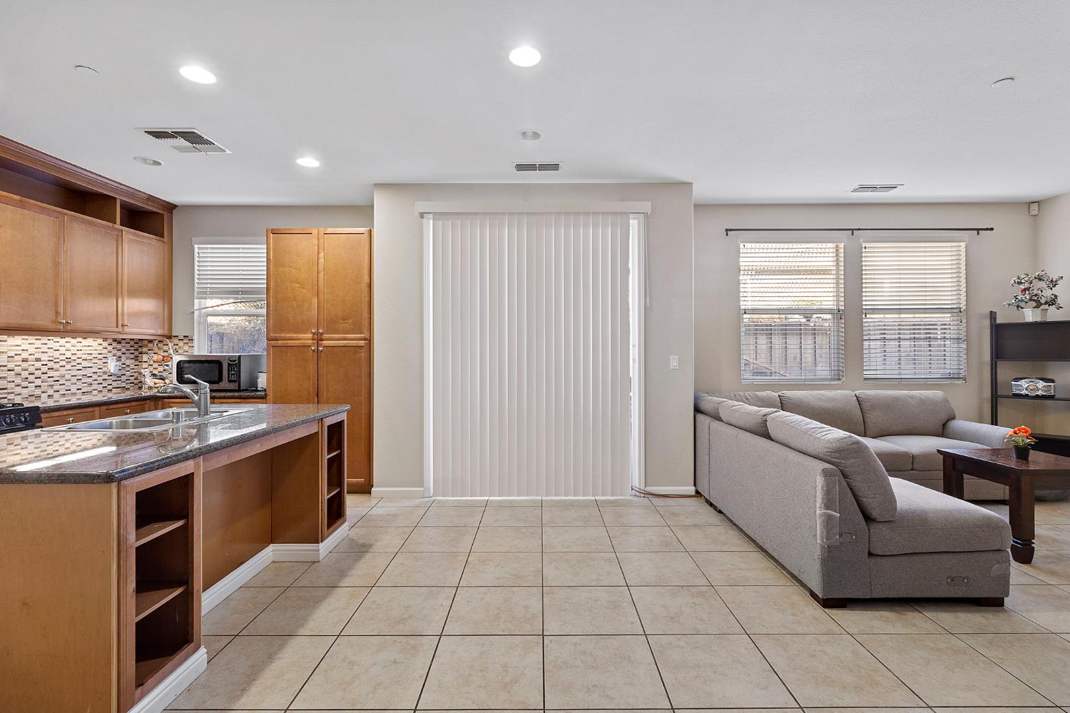 7525 Eldred Way Sacramento, CA 95829 - Photo 14 of 32 a kitchen with stainless steel appliances granite countertop a stove a sink and a refrigerator