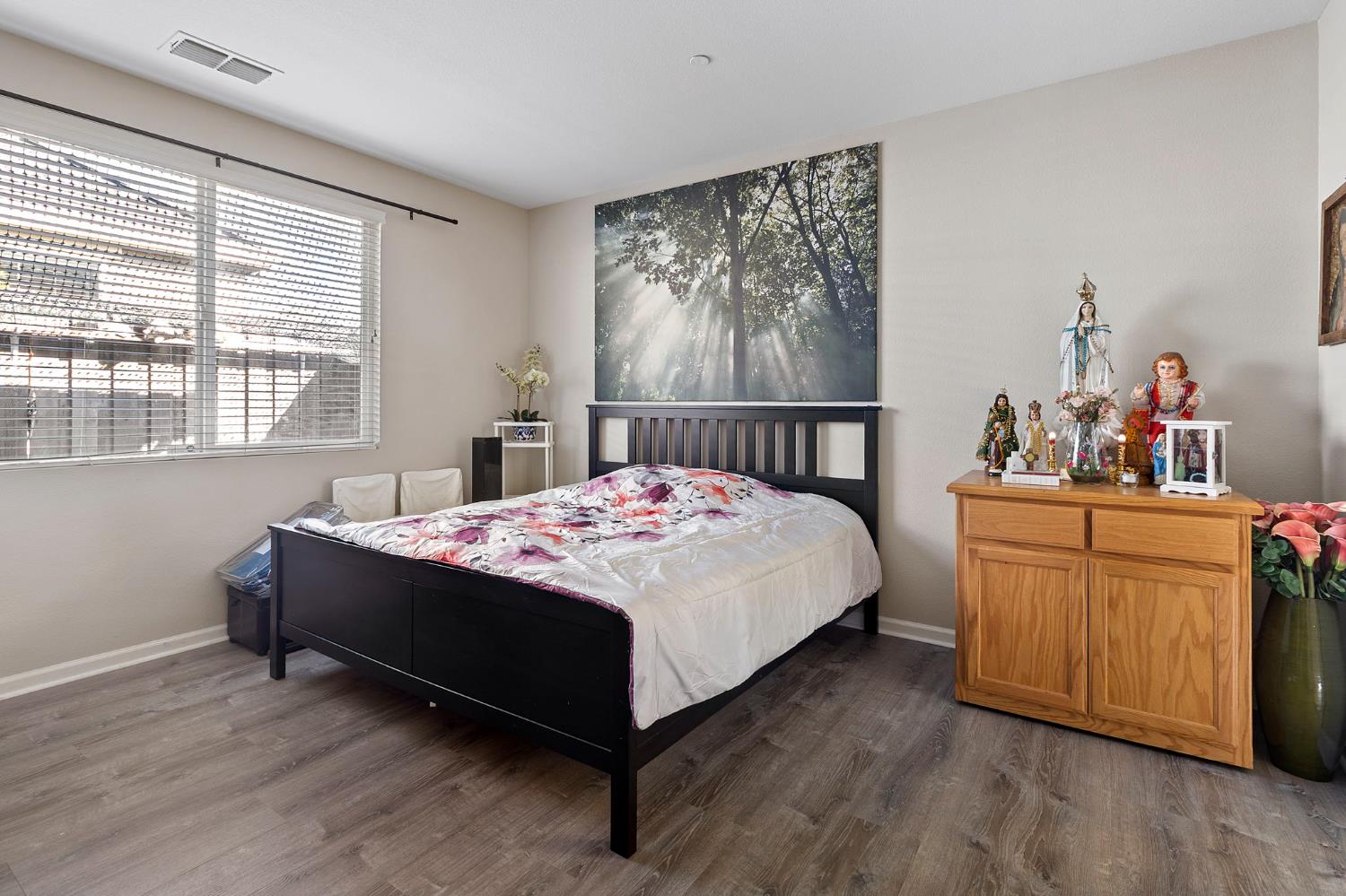 7525 Eldred Way Sacramento, CA 95829 - Photo 2 of 32 a bed sitting in a bedroom next to a window