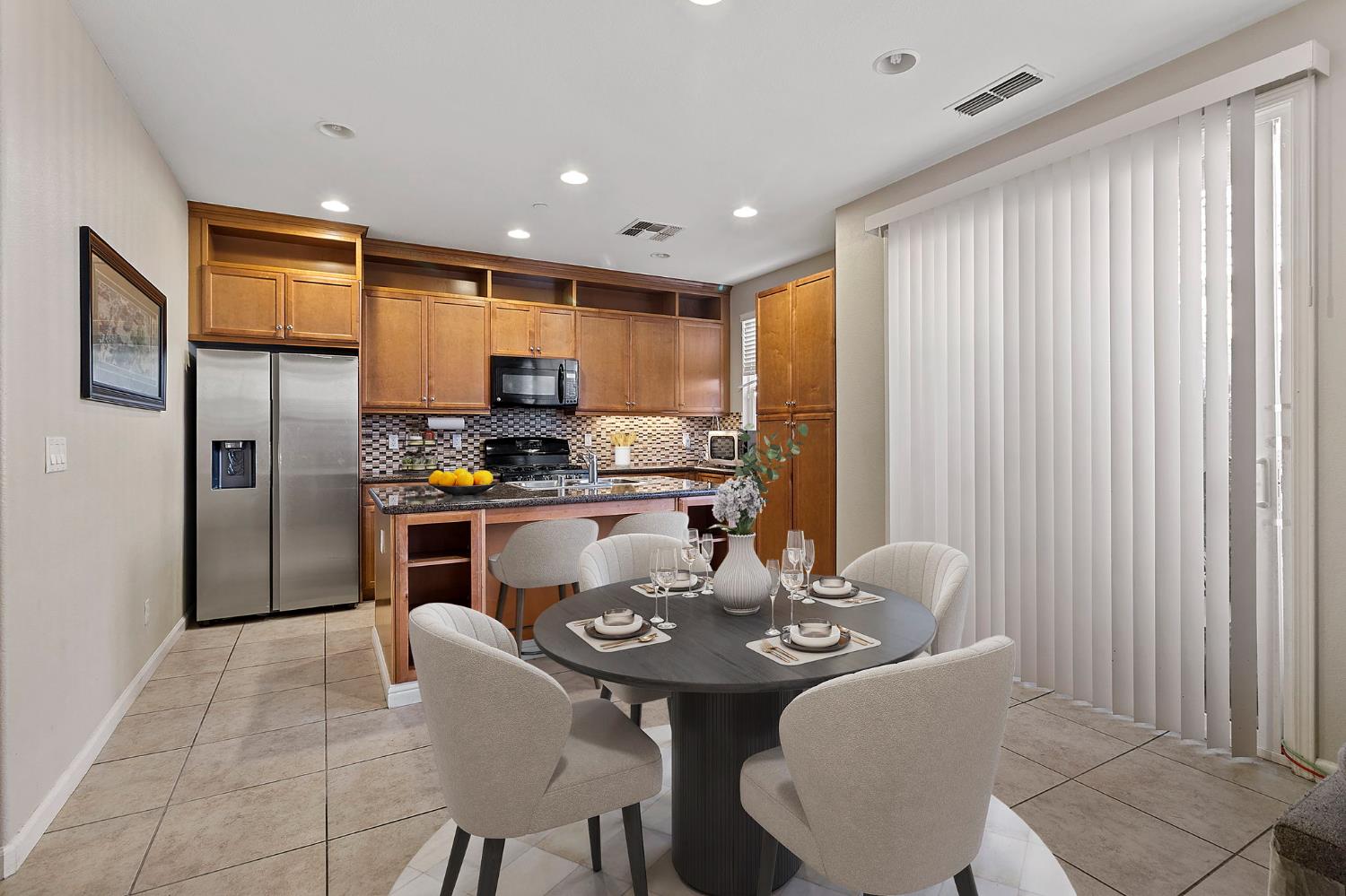 7525 Eldred Way Sacramento, CA 95829 - Photo 3 of 32 a kitchen with a table chairs refrigerator and cabinets