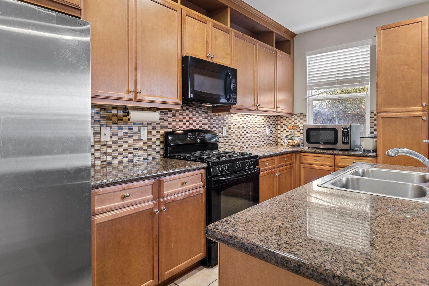 7525 Eldred Way Sacramento, CA 95829 - Photo 5 of 32 a kitchen with granite countertop a sink and a stove top oven