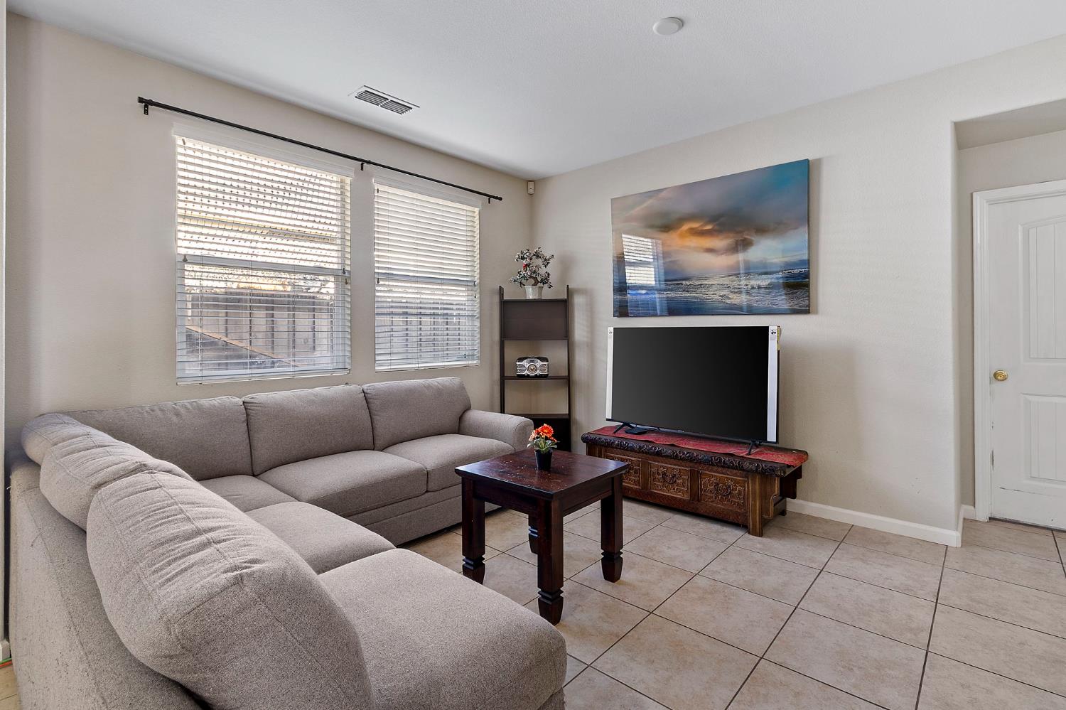 7525 Eldred Way Sacramento, CA 95829 - Photo 10 of 32 a living room with furniture and a flat screen tv
