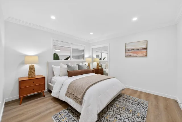 a spacious bedroom with a bed and a lamp