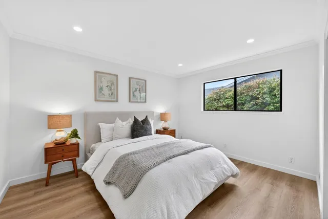 a bedroom with a bed and a night stand