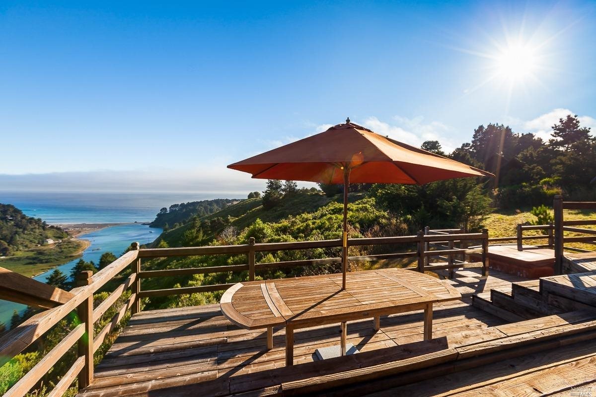 a view of a roof deck with couches and wooden floor