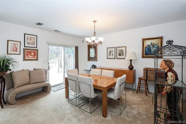 a view of a livingroom and a dining room with furniture window and wooden floor