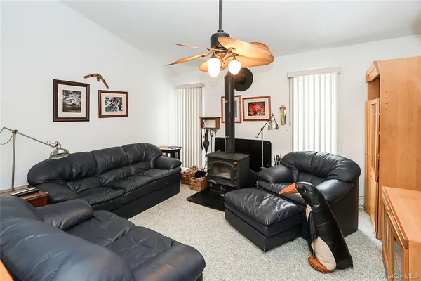 a living room with furniture a chandelier and a window