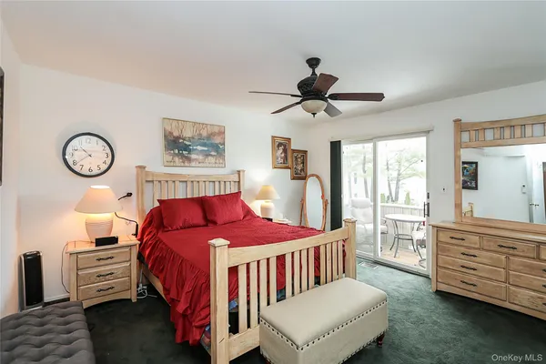 a bedroom with a bed a dresser and chair