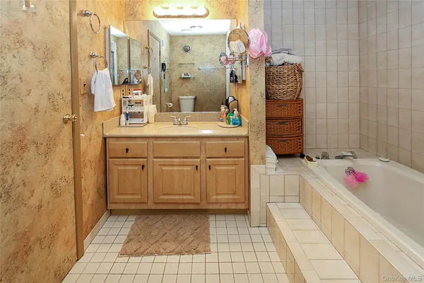 a spacious bathroom with a sink mirror and shower