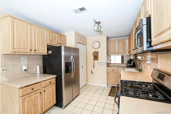 a kitchen with a refrigerator a stove a microwave and cabinets