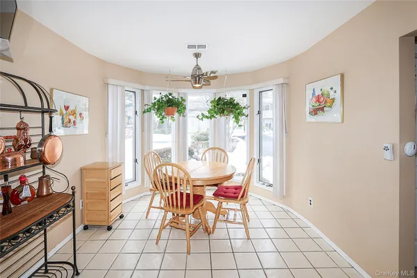 a dining room with furniture a chandelier and window
