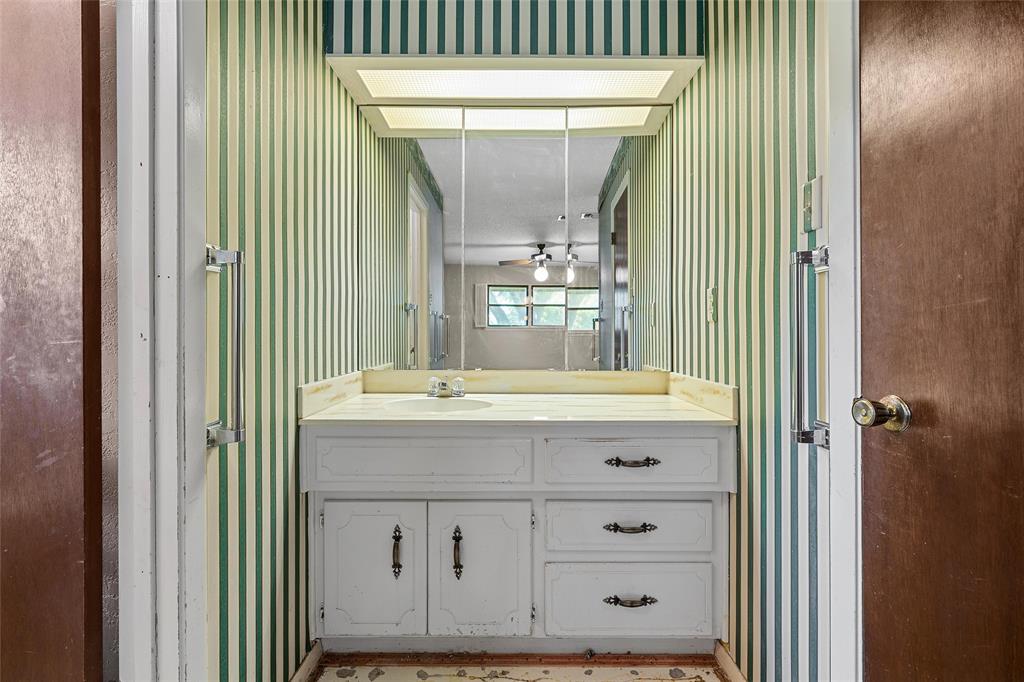 219 Opal Street Hewitt, TX 76643 - Photo 20 of 28 a bathroom with a sink a mirror and a shower