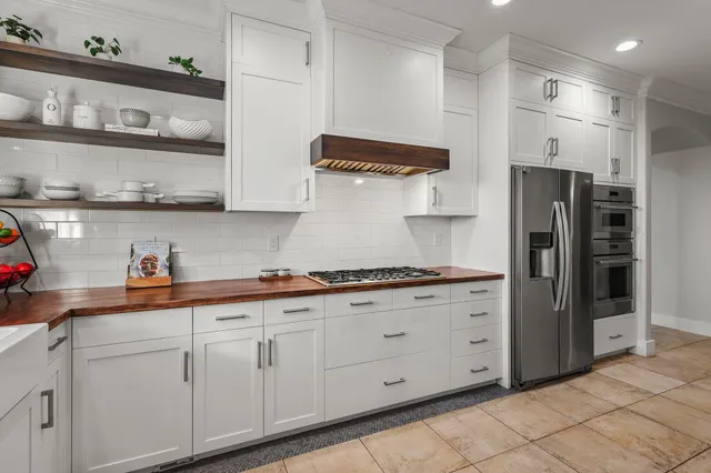 a kitchen with a sink stove and cabinets