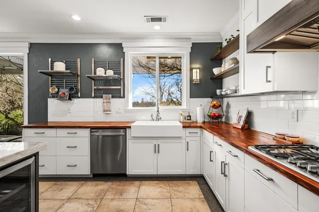 a view of kitchen with granite countertop cabinets a dining table and chairs
