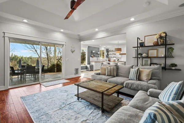 a spacious bedroom with a bed a couch and a large window