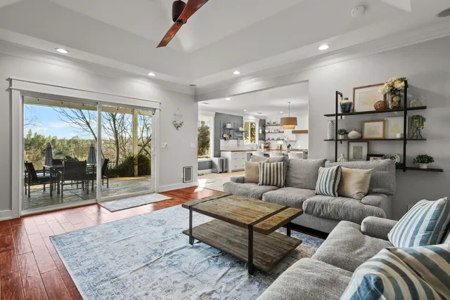 a spacious bedroom with a bed a couch and a large window