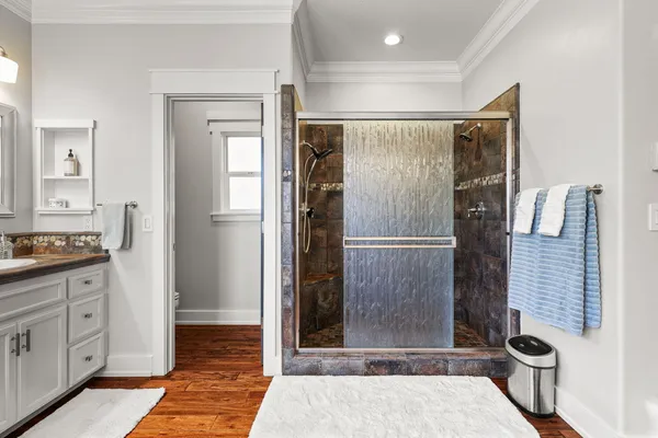 a spacious bathroom with double sink and a large mirror