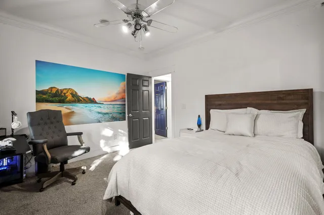 a bedroom with a large bed and a large window