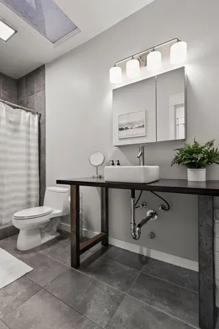 a bedroom with a large bed and a flat tv screen on dresser