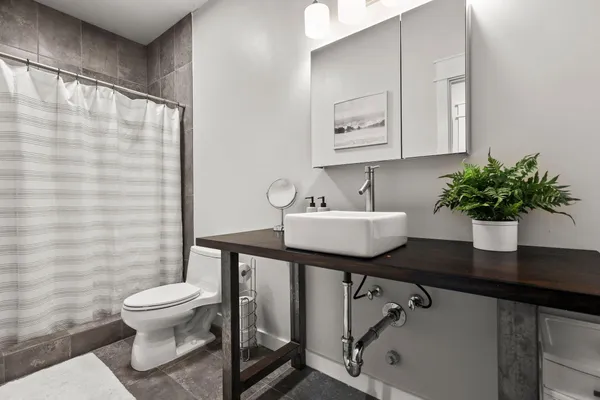 a bedroom with a large bed and a flat tv screen on dresser